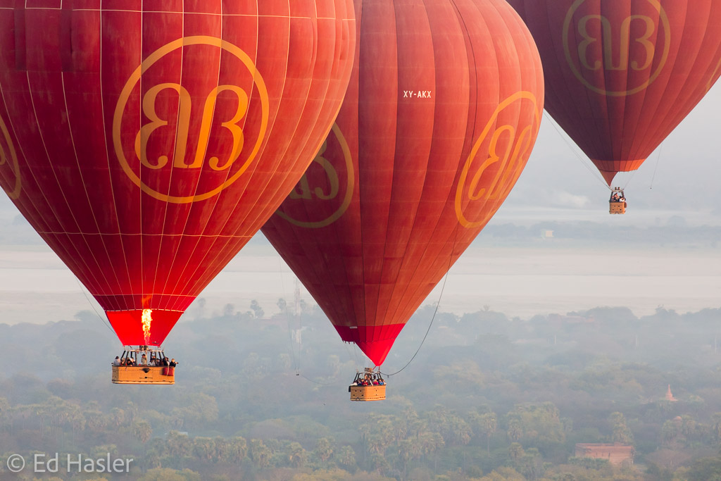 Three balloons floating above Bagan